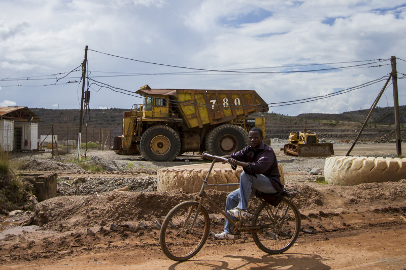 A man rids his bike across the vast mining lands outside Kolwezi in southeastern Congo. photo credit: Jacob Kushner