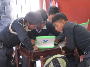 Kids in Peru crowd around a laptop. © Christoph Derndorfer 